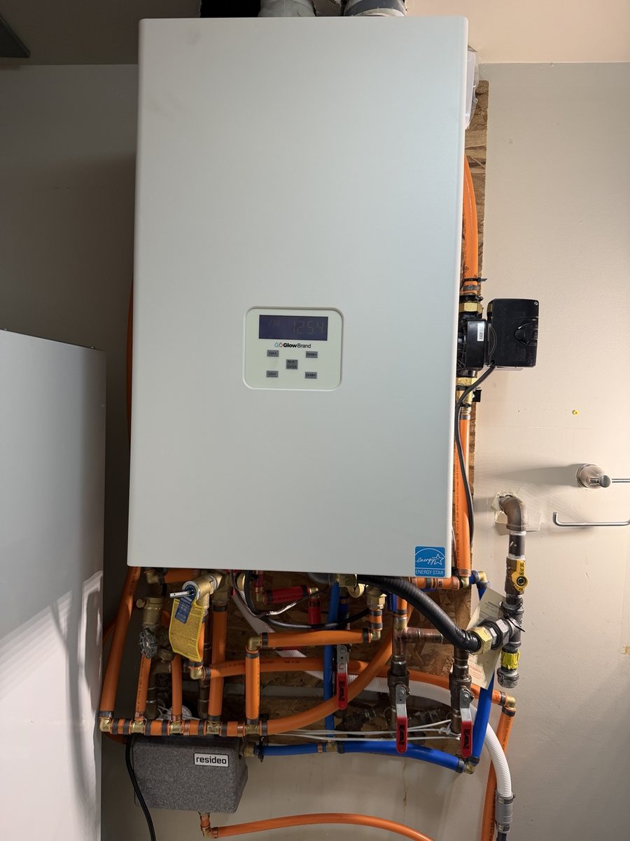 Hydronic boiler installation with orange and blue piping