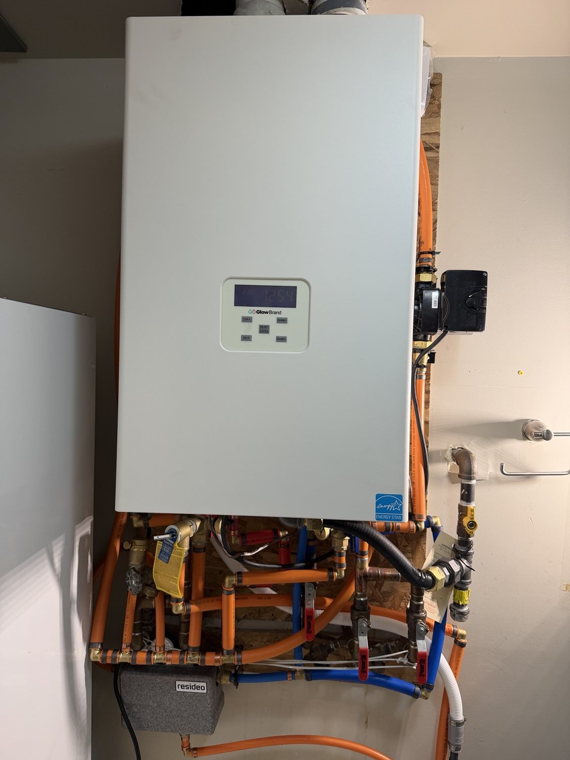 Hydronic boiler installation with orange and blue piping