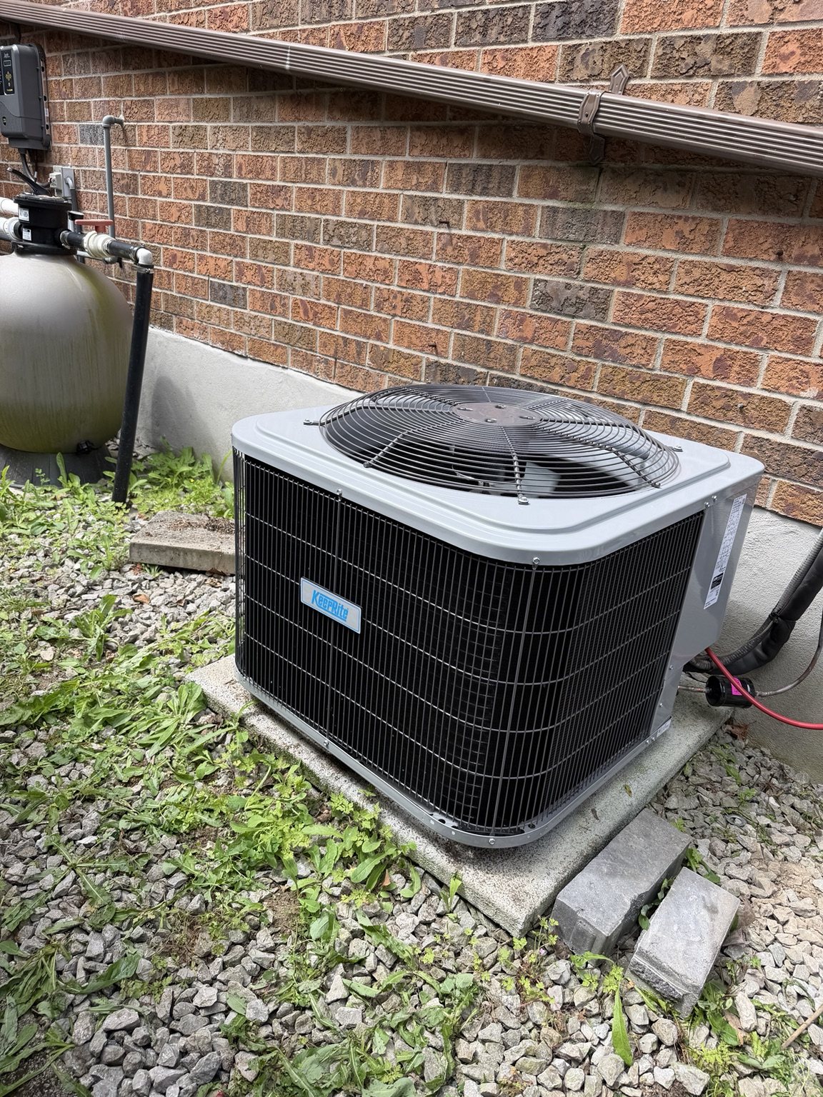 Keeprite outdoor air conditioner installation beside brick wall