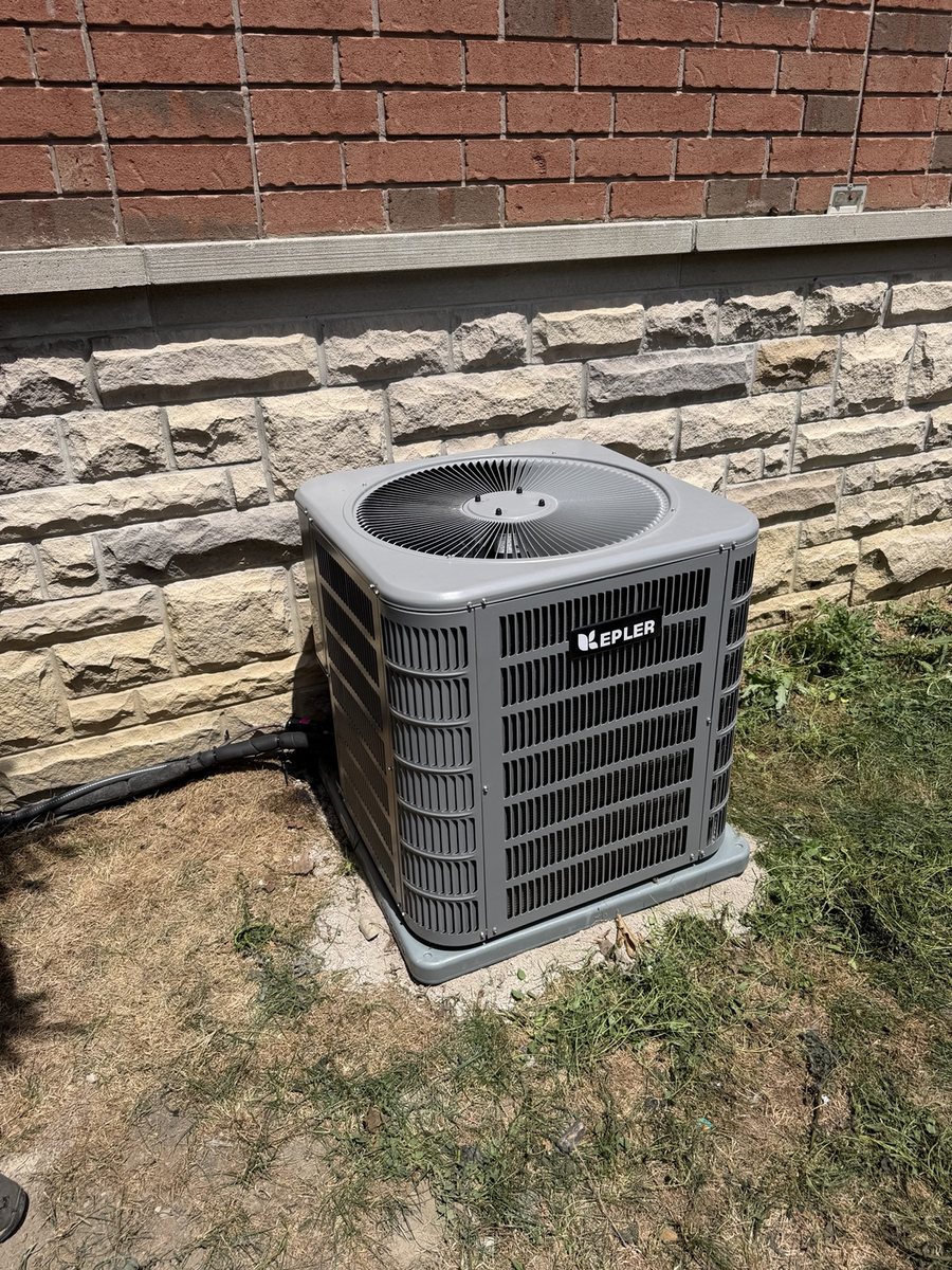 Kepler outdoor air conditioning condenser installation beside brick wall
