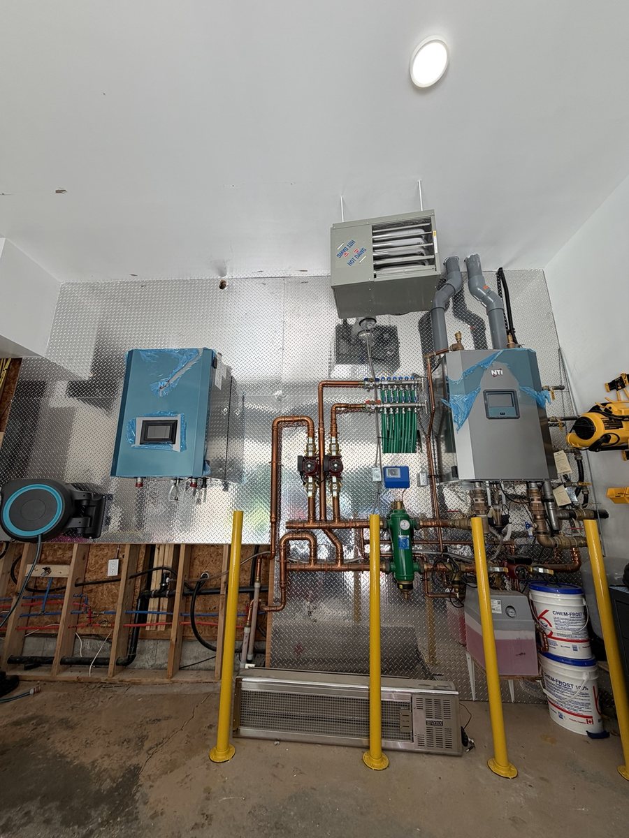 Large mechanical room hydronic heating system with copper pipes and manifolds